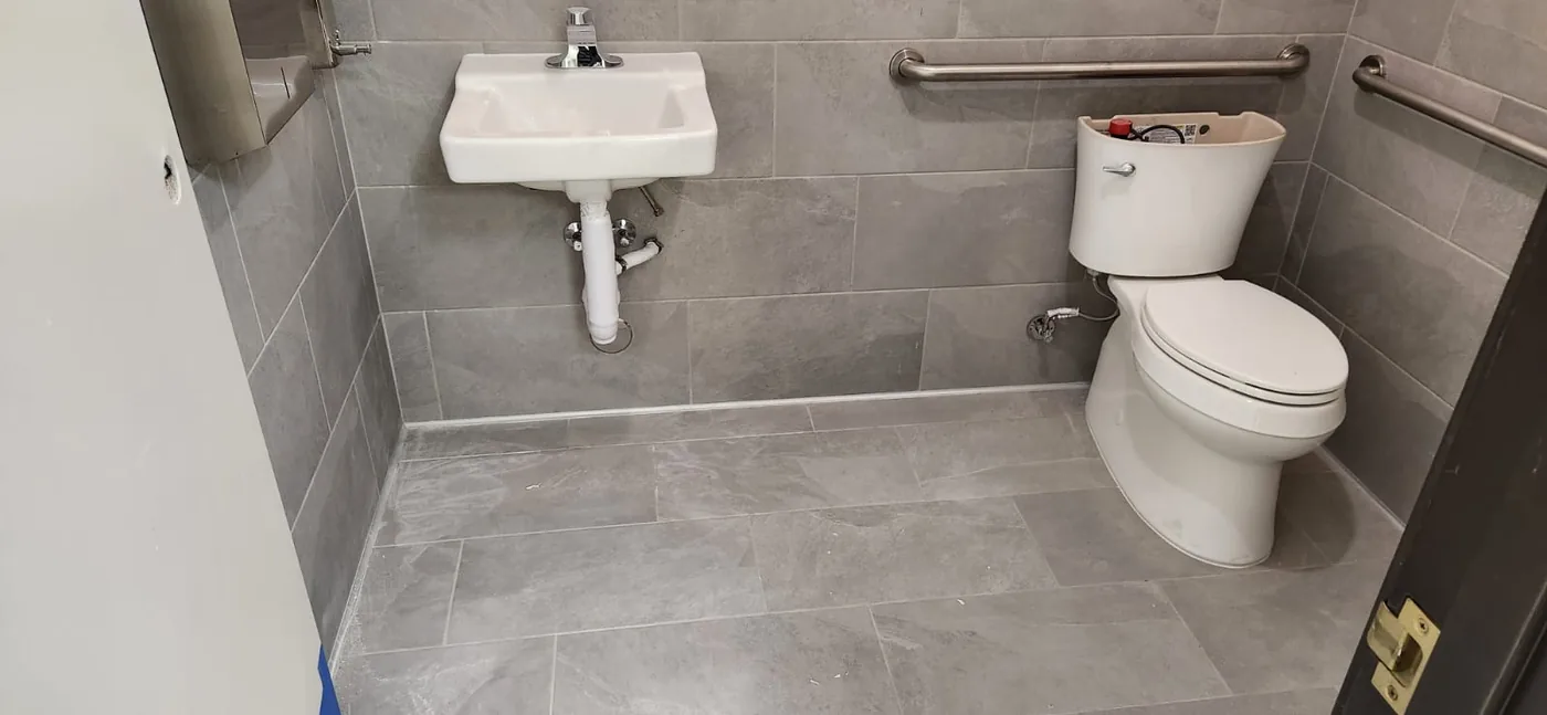 Commercial restroom plumbing fixture installation